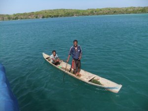 Our first friends in the channel.  They paddled that boat for 4 hours every day to tend their crop
