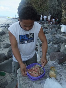 Mixing raw tuna for kinilaw on a beach in Anilao.